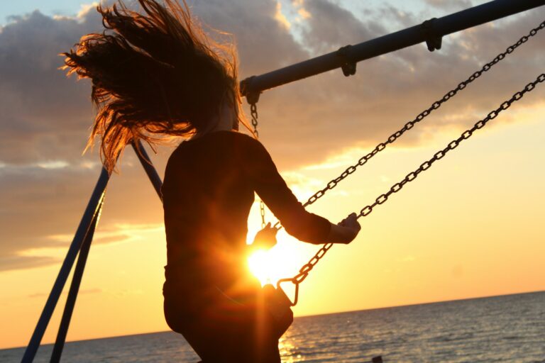 woman riding on swing during sunset capturing life aesthetics