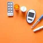white digital device beside white pen for Type 1 Diabetes management