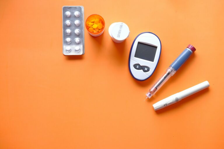 white digital device beside white pen for Type 1 Diabetes management