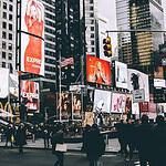 group of people walking along the street near buildings